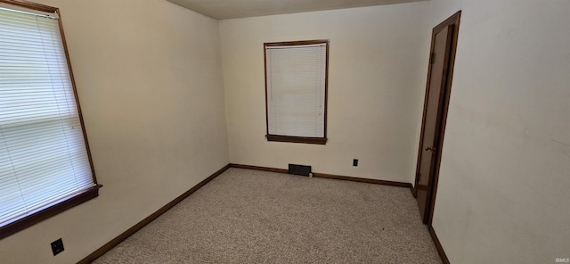 empty room with light colored carpet and baseboards