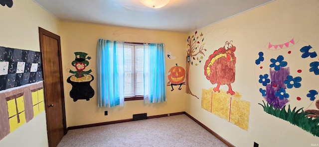 carpeted empty room with baseboards