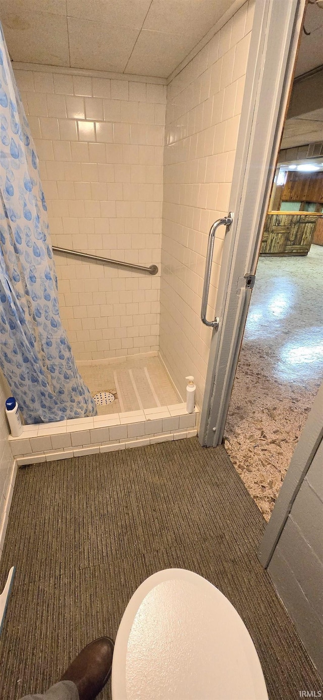 full bath featuring toilet and a shower stall