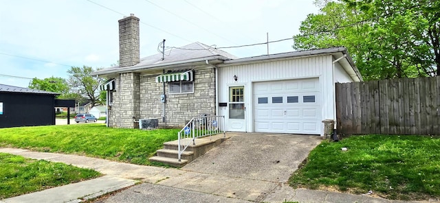 exterior space featuring driveway, a chimney, fence, a front lawn, and stone siding