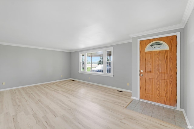 9231 Minnich Rd, Fort Wayne, IN 46816 - entrance foyer with crown molding, baseboards, wood finished floors, and visible vents