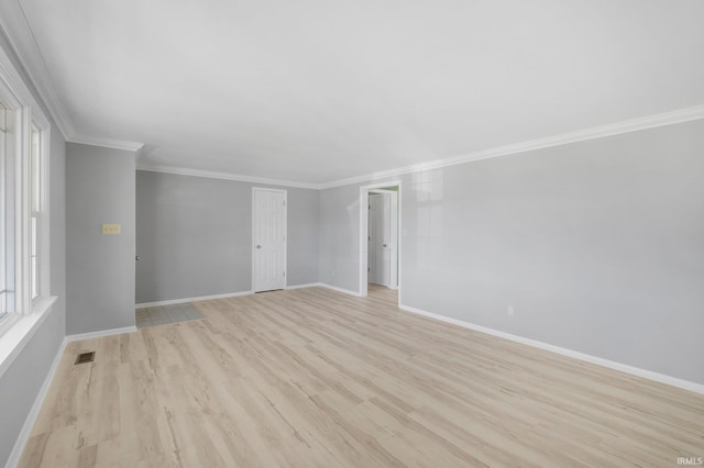 9231 Minnich Rd, Fort Wayne, IN 46816 - unfurnished living room with baseboards, visible vents, ornamental molding, and light wood-style flooring