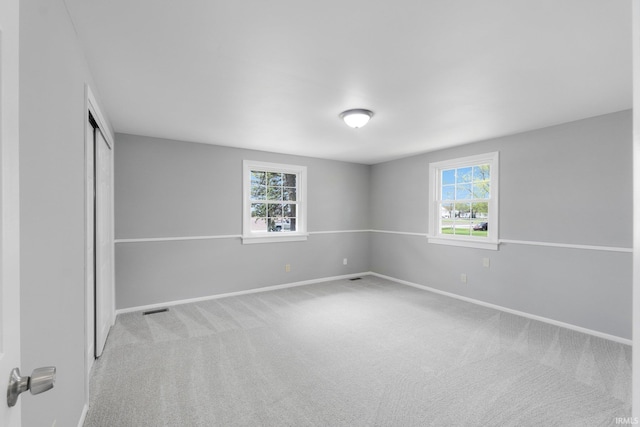 9231 Minnich Rd, Fort Wayne, IN 46816 - spare room featuring carpet floors, visible vents, baseboards, and a wealth of natural light