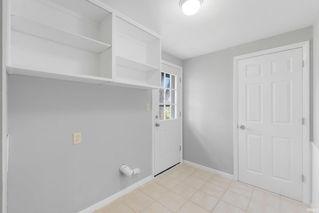 9231 Minnich Rd, Fort Wayne, IN 46816 - laundry area with light tile patterned flooring, baseboards, and laundry area