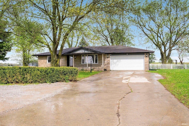 9231 Minnich Rd, Fort Wayne, IN 46816 - ranch-style house featuring brick siding, fence, a front lawn, concrete driveway, and an attached garage