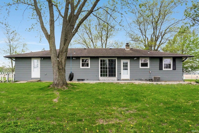 9231 Minnich Rd, Fort Wayne, IN 46816 - back of property with a lawn, a chimney, and central air condition unit