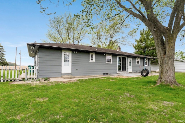 9231 Minnich Rd, Fort Wayne, IN 46816 - back of property with a lawn, a patio area, fence, and a chimney