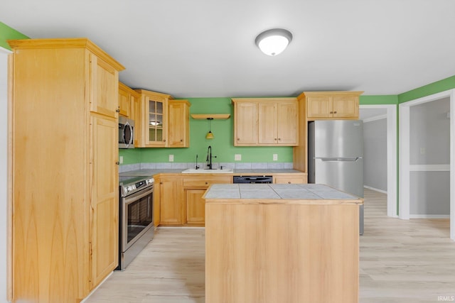 9231 Minnich Rd, Fort Wayne, IN 46816 - kitchen with light wood-style floors, appliances with stainless steel finishes, a sink, and light brown cabinets