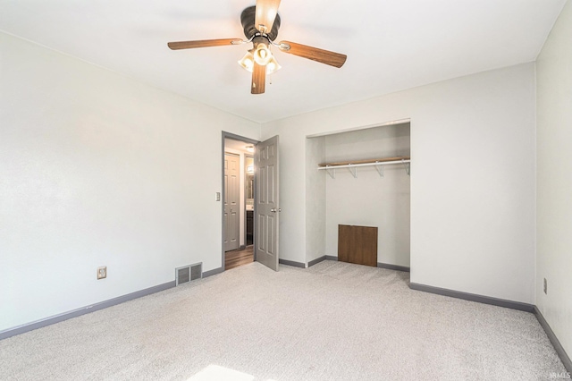 unfurnished bedroom with baseboards, visible vents, carpet, and a closet