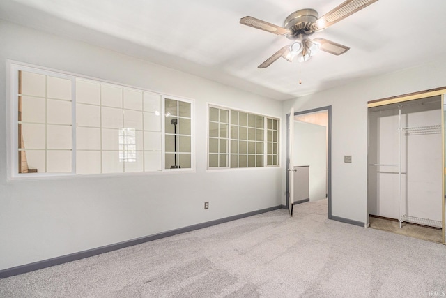 unfurnished bedroom with carpet floors, baseboards, ceiling fan, and a closet