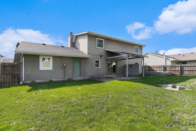 rear view of house featuring a lawn, a chimney, a fenced backyard, and a patio area