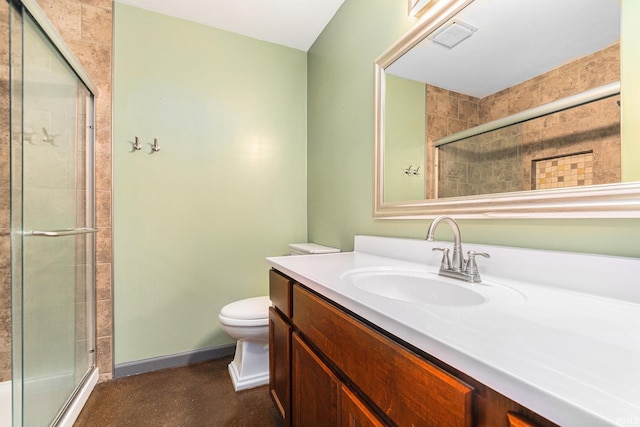 bathroom with vanity, concrete flooring, toilet, baseboards, and a tile shower