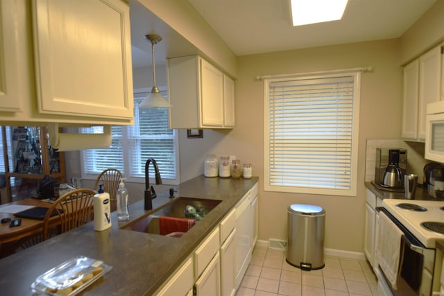 10035 N Turkey Creek Rd, Syracuse, IN 46567 - kitchen with light tile patterned flooring, dark countertops, white appliances, white cabinets, and a sink