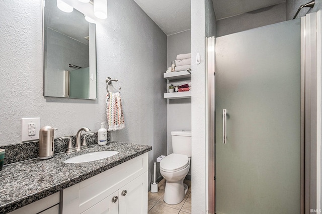29130 County Road 22, Elkhart, IN 46517 - bathroom featuring tile patterned flooring, a shower stall, vanity, toilet, and a textured wall
