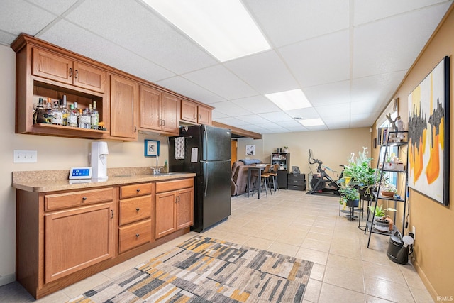 29130 County Road 22, Elkhart, IN 46517 - kitchen with light countertops, light tile patterned floors, freestanding refrigerator, and a paneled ceiling