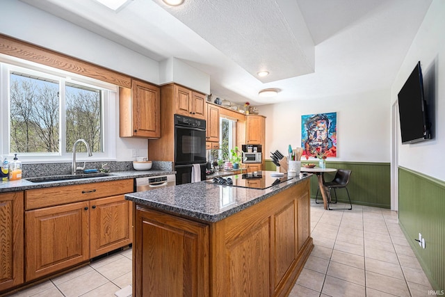 29130 County Road 22, Elkhart, IN 46517 - kitchen with wainscoting, a sink, plenty of natural light, a kitchen island, and black appliances
