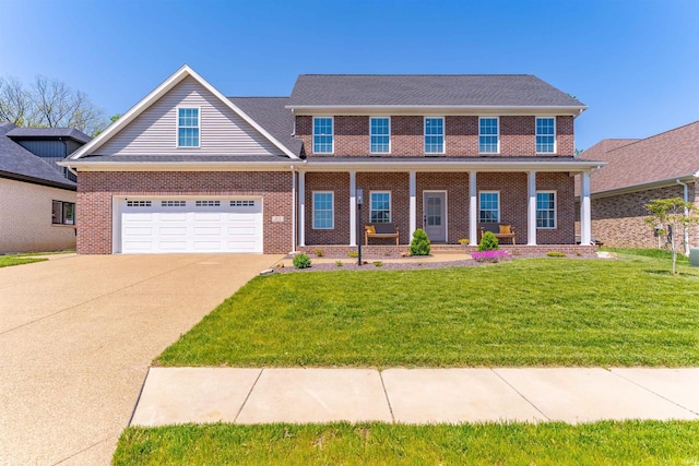view of front of home with concrete driveway, brick siding, a porch, and a front lawn