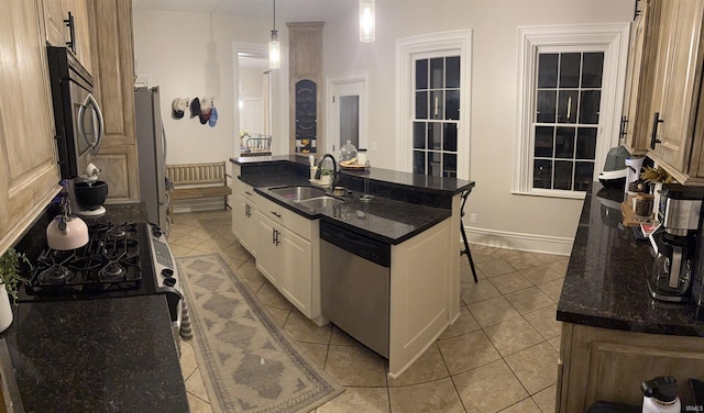 13546 Brick Rd, Granger, IN 46530 - kitchen featuring a center island with sink, white cabinets, a sink, appliances with stainless steel finishes, and light tile patterned floors