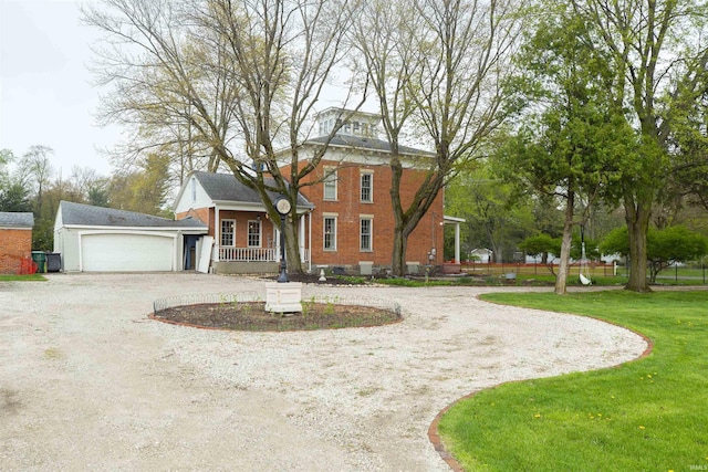 13546 Brick Rd, Granger, IN 46530 - view of front of house featuring covered porch, brick siding, curved driveway, a front lawn, and an attached garage