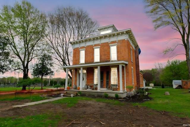 13546 Brick Rd, Granger, IN 46530 - italianate-style house featuring brick siding, a yard, and a porch