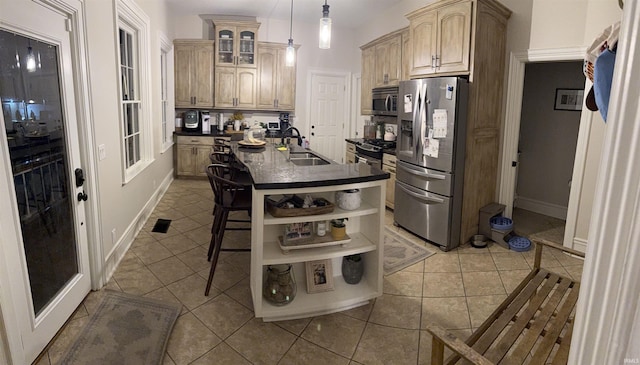 13546 Brick Rd, Granger, IN 46530 - kitchen featuring open shelves, a kitchen island with sink, dark countertops, a sink, and appliances with stainless steel finishes