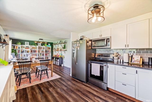 kitchen with white cabinets, tasteful backsplash, dark wood-style floors, and stainless steel appliances