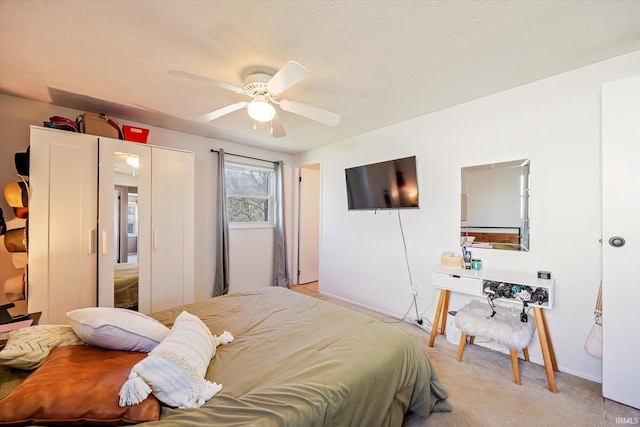 bedroom with a ceiling fan, baseboards, and light carpet