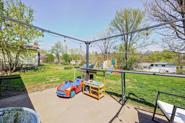 view of patio / terrace featuring a playground and fence
