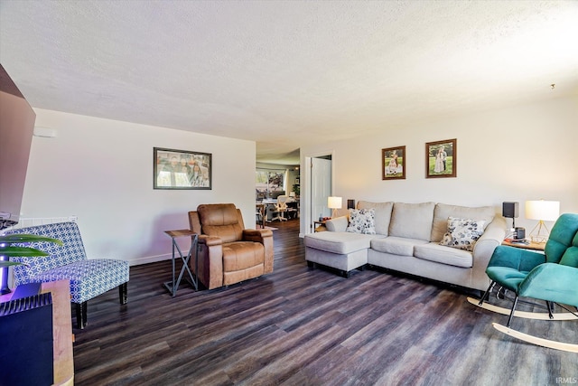 living room with baseboards, a textured ceiling, and wood finished floors