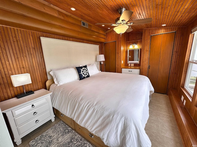 tiled bedroom with wooden walls, wooden ceiling, and visible vents