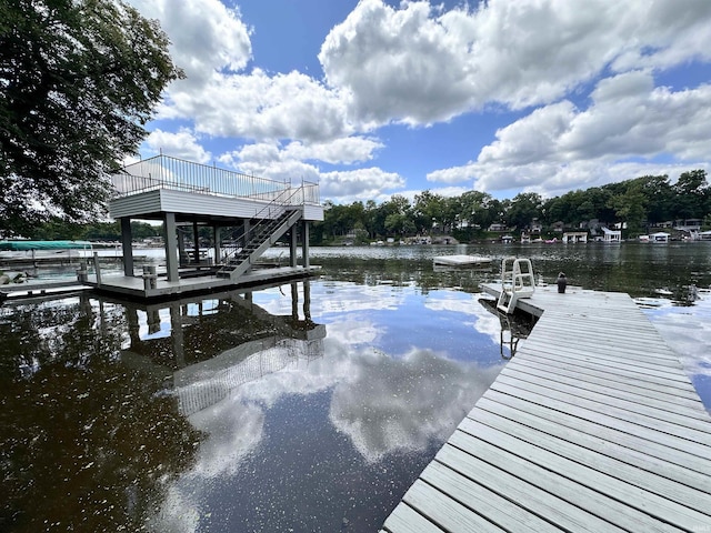 view of dock featuring stairs and a water view