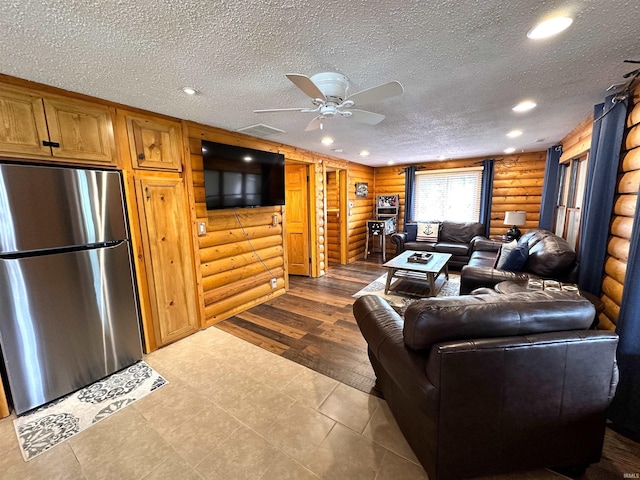 living room with a ceiling fan, a textured ceiling, visible vents, log walls, and recessed lighting