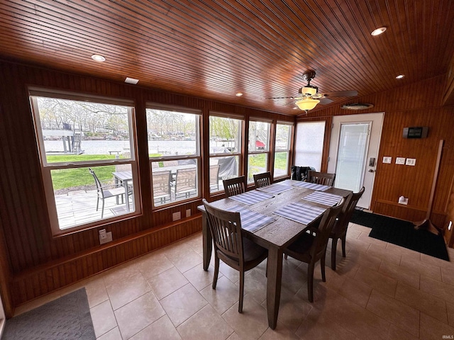dining room with wood walls, light tile patterned flooring, a wealth of natural light, and wooden ceiling