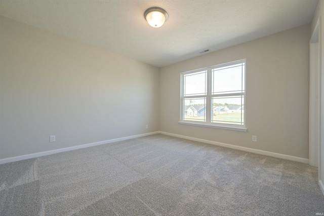 empty room with baseboards and light colored carpet