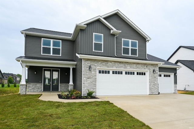 craftsman inspired home featuring an attached garage, a front lawn, stone siding, and concrete driveway