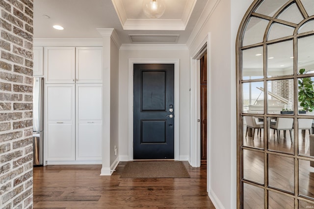 entryway featuring brick wall, visible vents, baseboards, ornamental molding, and dark wood-type flooring