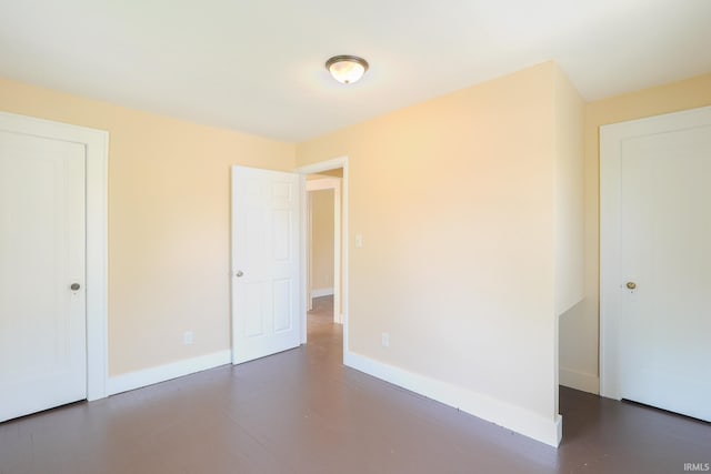 unfurnished bedroom with baseboards and a closet