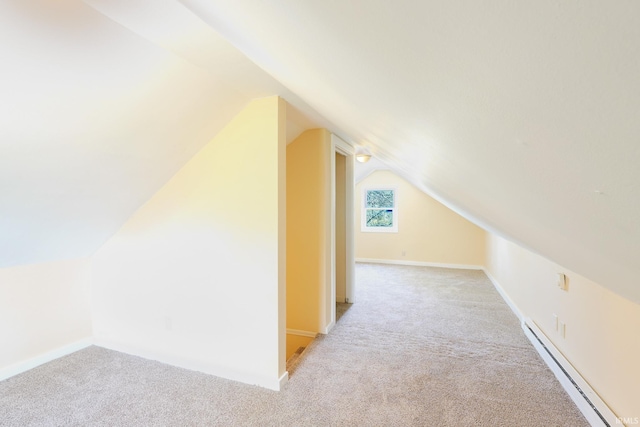 additional living space with baseboards, carpet, lofted ceiling, and a baseboard heating unit