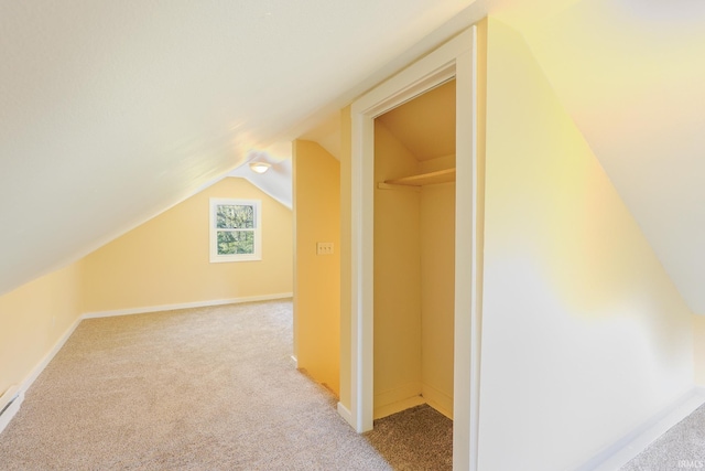 bonus room featuring baseboards, light colored carpet, and lofted ceiling