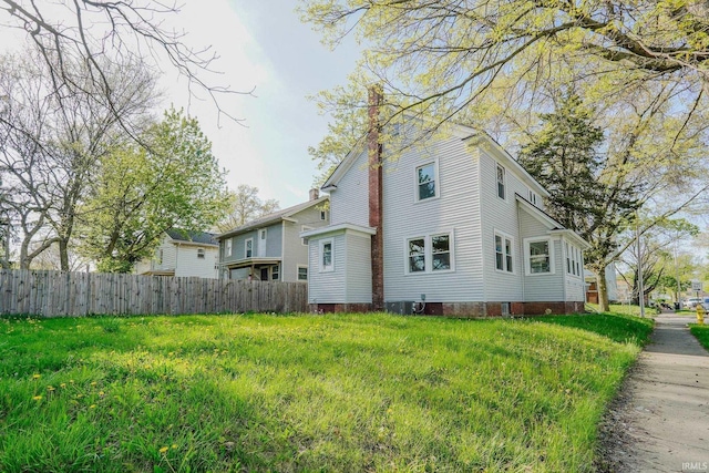 exterior space with fence and a chimney