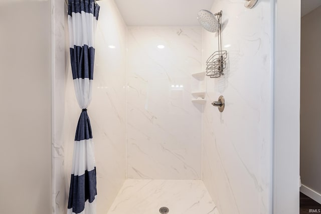 full bathroom featuring a marble finish shower