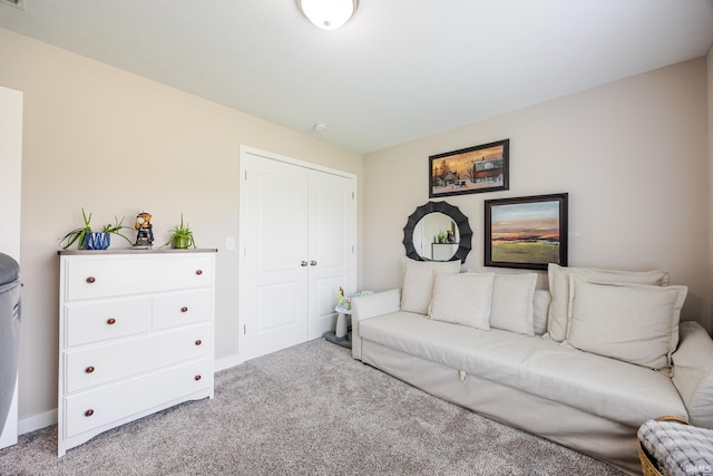 carpeted living area featuring baseboards and visible vents
