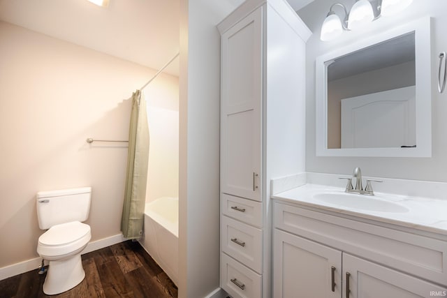 bathroom with shower / tub combo with curtain, vanity, toilet, baseboards, and wood finished floors