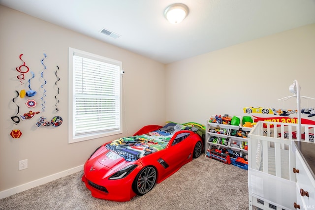 carpeted bedroom featuring baseboards and visible vents