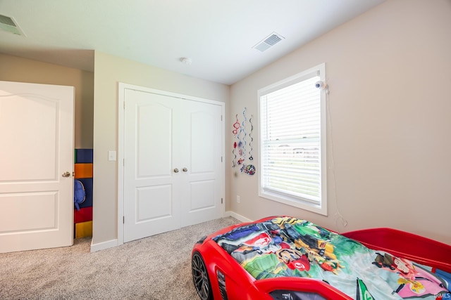 carpeted bedroom with baseboards and visible vents