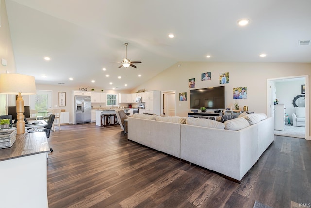 living area featuring visible vents, high vaulted ceiling, recessed lighting, a ceiling fan, and dark wood finished floors