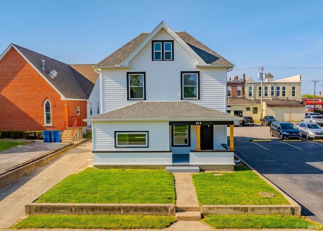 219 E S A St, Gas City, IN 46933 - american foursquare style home with uncovered parking, roof with shingles, covered porch, and a front yard