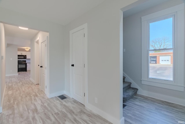219 E S A St, Gas City, IN 46933 - hallway with baseboards, stairs, light wood-style flooring, and visible vents