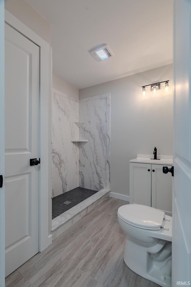 219 E S A St, Gas City, IN 46933 - bathroom featuring vanity, toilet, a marble finish shower, wood finished floors, and visible vents