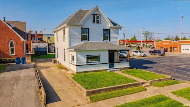 219 E S A St, Gas City, IN 46933 - view of front of home featuring roof with shingles, a front lawn, and uncovered parking
